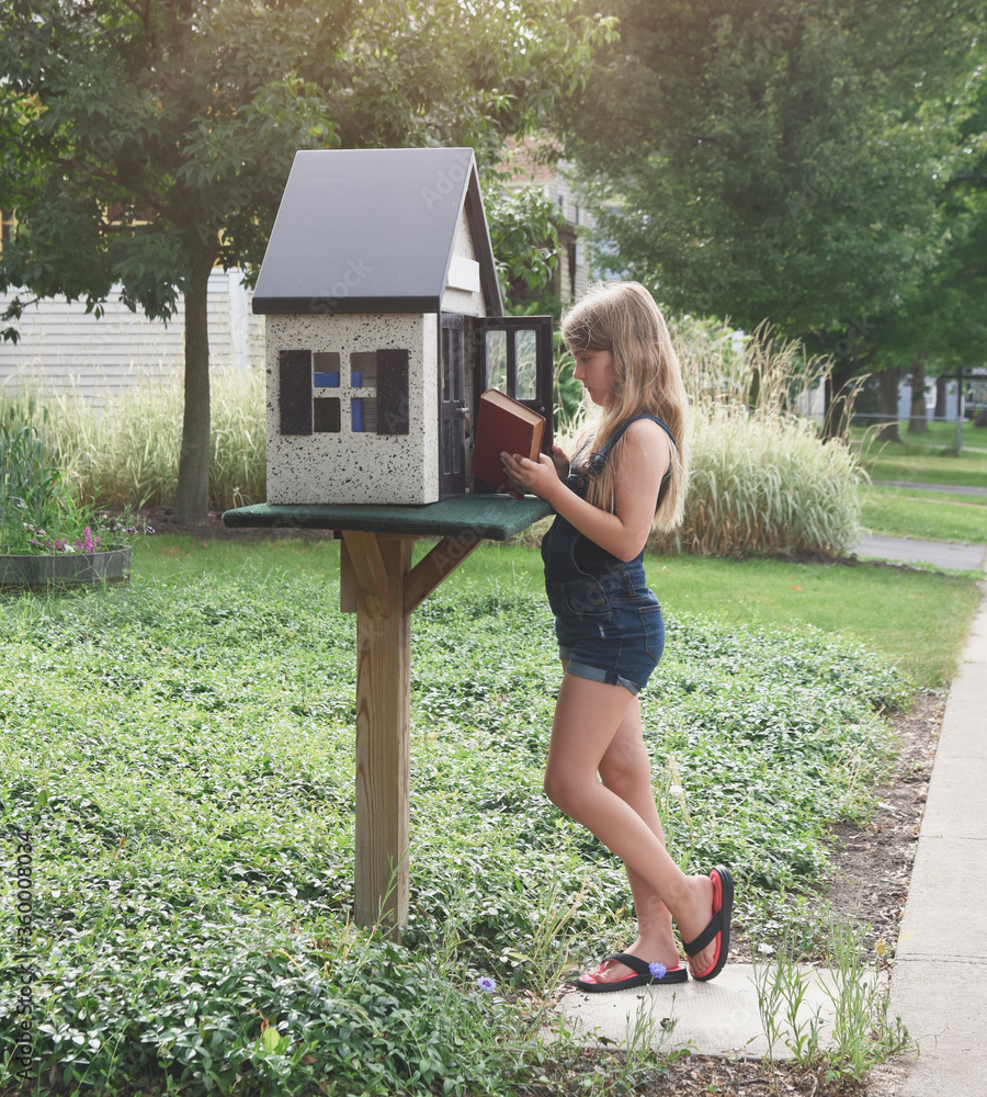 Child Choosing New Book at Free Mini Library