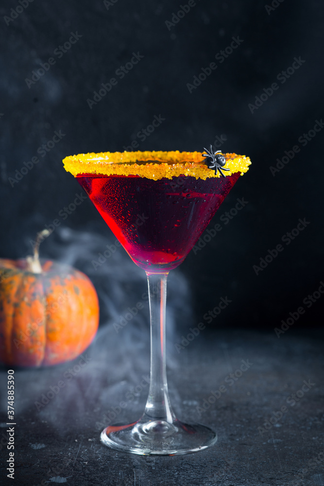 Halloween coctail black widow with red drinks in glass on dark background