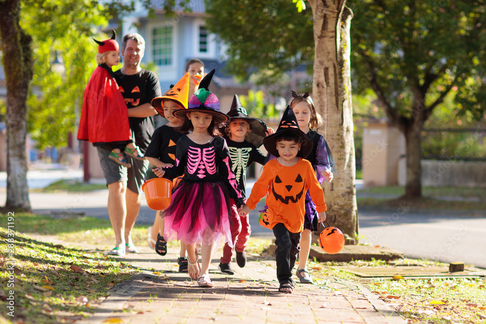 Kids trick or treat. Halloween fun for children.