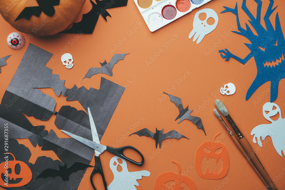 Photo of halloween backgrounds with paper ghosts, pumpkin, skulls