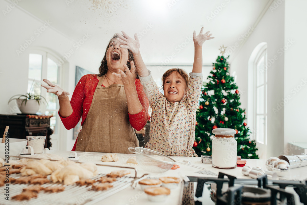 Mother and daughter having fun while making Christmas cookies.